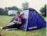 [Photo of Mark peering out of his tent]